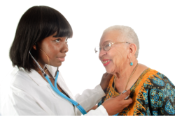 a nurse checking old woman's heartbeat